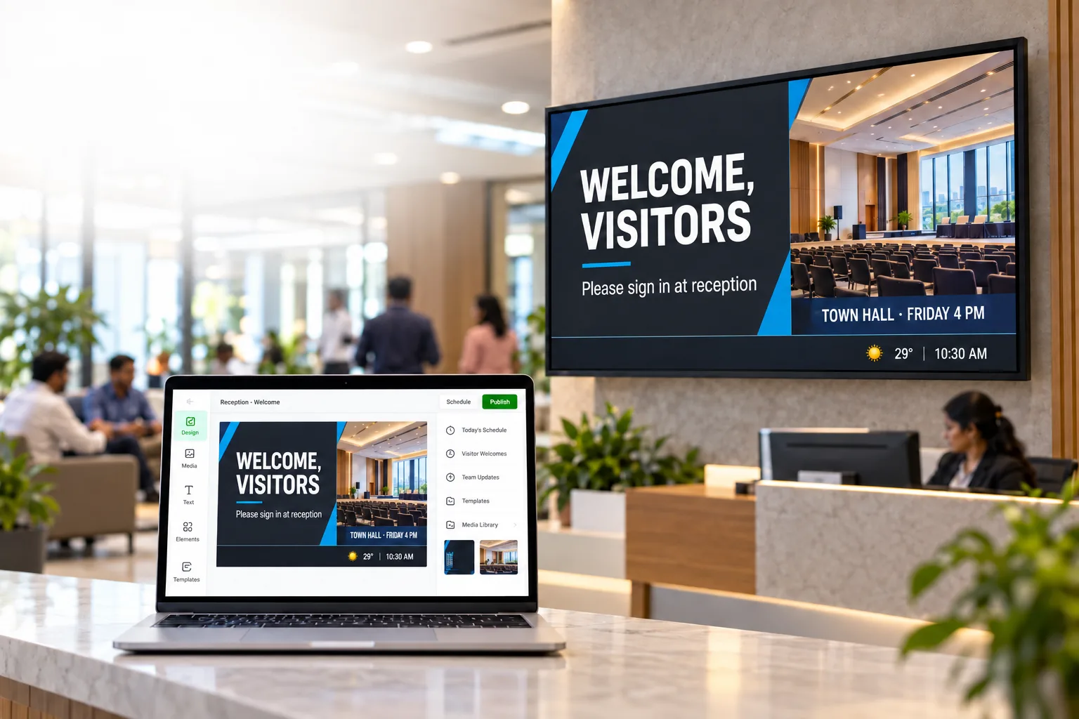 A visitor welcome and town hall screen in an office reception, with the same design open in Laavia Design on a laptop